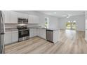 Modern kitchen with stainless steel appliances, granite countertops, and an open layout with natural light at 247 Big Sioux Dr, Poinciana, FL 34759
