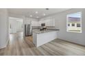 Well-lit kitchen with stainless steel appliances, breakfast bar, granite countertops, and modern cabinetry at 247 Big Sioux Dr, Poinciana, FL 34759