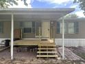 Exterior front entrance with a new wooden porch and awning at 2777 Cr 673, Bushnell, FL 33513