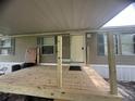 Covered front porch with wood supports and a new wooden floor at 2777 Cr 673, Bushnell, FL 33513
