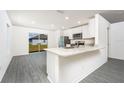 Modern kitchen with white cabinets, stainless steel appliances and granite countertops at 3715 Bergamot St, Lake Alfred, FL 33850