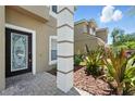 Close-up view of the decorative front door and well-manicured landscaping adding to the home's charm at 5233 Los Palma Vista Dr, Orlando, FL 32837