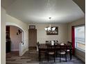 Inviting dining room featuring wood floors, stylish light fixture and plenty of space for Gathering gatherings at 701 N 7Th St, Haines City, FL 33844