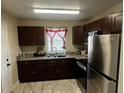 Well-lit kitchen with stainless steel appliances, granite countertops, and ample cabinet space at 701 N 7Th St, Haines City, FL 33844