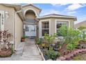 Beautiful front entrance with a decorative door, an arched entrance, and professional landscaping at 1955 Manatee Ct, Kissimmee, FL 34759