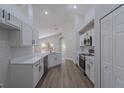 Spacious kitchen featuring white cabinets, stainless steel appliances, and a view to the backyard at 316 Red Kite Dr, Groveland, FL 34736