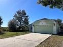 Single story home with a large driveway and well-maintained lawn, offering a blend of comfort and suburban charm at 103 Thornbush Pkwy, Davenport, FL 33837