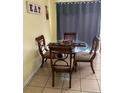 Cozy dining area featuring a glass-topped table with seating for four guests at 110 N Chester St, Leesburg, FL 34748