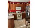 Functional kitchen with ample counter space, modern appliances, and warm wood cabinetry at 110 N Chester St, Leesburg, FL 34748