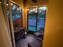 Screened patio with string lights, chairs, grill, and brick wall at 1634 Plumeria Pl, Oviedo, FL 32765
