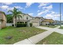 Charming two-story home with a well-maintained lawn and a two-car garage in a quiet neighborhood at 16828 N Gold Star Ct, Clermont, FL 34714