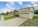 Charming two-story home with a well-maintained lawn and a two-car garage in a quiet neighborhood at 16828 N Gold Star Ct, Clermont, FL 34714