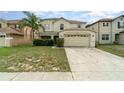 Inviting two-story home with a lush lawn and two-car garage, perfect for suburban living at 16828 N Gold Star Ct, Clermont, FL 34714