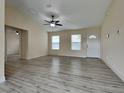 Bright living room featuring new floors, a ceiling fan, and natural light from multiple windows at 16910 Sw 27 Avenue, Ocala, FL 34473