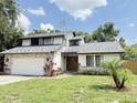 Charming two-story home with a well-maintained lawn and stone accents, with an attached two-car garage at 4662 Tiffany Woods Cir, Oviedo, FL 32765
