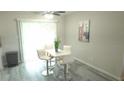 Cozy dining area featuring modern white furniture, neutral decor, and lots of natural light at 5834 Forest Grove Blvd, Orlando, FL 32808