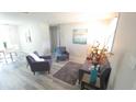 Inviting living room showcasing stylish furnishings, neutral walls, and wood-look flooring for a fresh aesthetic at 5834 Forest Grove Blvd, Orlando, FL 32808