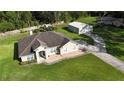 Aerial view of a lovely home with a spacious yard and separate garage/workshop at 33632 Wesley Rd, Eustis, FL 32736