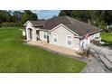 Beautiful home exterior with a well-kept lawn and walkway leading to the front door at 33632 Wesley Rd, Eustis, FL 32736