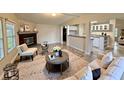 Inviting living room with fireplace, neutral color palette, and open concept design to kitchen at 4861 Myrtle View N Dr, Mulberry, FL 33860