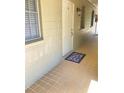 Hallway of a condo featuring a tiled floor, windows, and unit number six at 223 Windsor St # 6, Lakeland, FL 33803