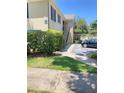 Charming condo building exterior with lush green lawn and a glimpse of available parking at 223 Windsor St # 6, Lakeland, FL 33803