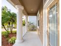 View of the front porch showing white columns and landscaping at 10084 Moss Rose Way, Orlando, FL 32832