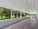 Expansive covered patio with tiled flooring, perfect for outdoor entertaining and enjoying scenic views at 2440 S Wallace Rd, Bartow, FL 33830