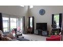Bright living room with high ceilings, large windows, and stylish furnishings at 6832 Thornhill Cir, Windermere, FL 34786