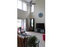 Bright living room with high ceilings, large windows, and stylish furnishings at 6832 Thornhill Cir, Windermere, FL 34786