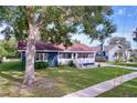 Charming single-story home featuring a cozy front porch and well-maintained lawn at 1938 E Fern Rd, Lakeland, FL 33801
