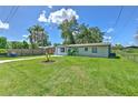 Home's front exterior with a large grassy yard at 475 W Ethelene St, Bartow, FL 33830