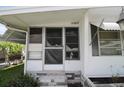 Home entrance view with plants, windows, and stone trim at 515 Cassandra Ln, Lakeland, FL 33809
