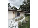 Charming single story home featuring a garden walkway and attractive brick accents at 204 Madison St, Minneola, FL 34715