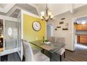 Bright dining area featuring a glass table, chandelier, and stylish decor; perfect for entertaining guests at 4711 Club Cir, Lakeshore, FL 33854