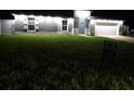 Well-lit single-story home featuring a manicured front yard and a 'For Sale' sign at 10090 Se 67Th Ter, Belleview, FL 34420