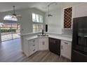 Bright kitchen with white cabinets, stainless steel appliances, and a breakfast bar at 13774 Meadowpark Ave, Orlando, FL 32826