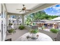 Cozy covered patio with ceiling fan, potted plants, and outdoor furniture for relaxing at 93 Bream St, Haines City, FL 33844