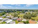 Aerial view of a residential neighborhood with mature trees and well-maintained homes at 1032 Kelsea Cir, The Villages, FL 32159