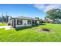 Well-maintained home showcasing a lush lawn and convenient attached garage at 2151 Groveglen S Ln, Lakeland, FL 33813