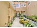 Inviting front entrance with a well-maintained garden and a walkway leading to the front door at 2256 Wekiva Village Ln, Apopka, FL 32703