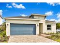 Attractive single-story house showcasing a blue garage door, manicured lawn and tasteful landscaping at 5793 Timber Meadow Way, St Cloud, FL 34771