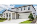 Attractive two-story home with a spacious two-car garage, covered porch, and green lawn at 2199 Broadbrook Drive, St Cloud, FL 34771