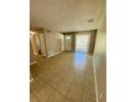 Bright living room featuring tile floors and natural light from a large window at 3802 Bryston Dr, Orlando, FL 32822