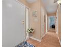 Welcoming entryway with tile flooring, flower arrangement and decorative wall art at 21078 Sw Honeysuckle St, Dunnellon, FL 34431