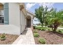 Inviting front entrance with a quaint, brick-paved walkway leading to the home's welcoming door at 3321 Pintello Ave, New Smyrna Beach, FL 32168