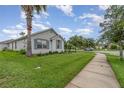 Attractive home features a neatly manicured lawn, complemented by mature trees providing ample shade at 3321 Pintello Ave, New Smyrna Beach, FL 32168