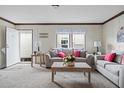 Inviting living room with neutral walls, matching sofas, and bright natural light at 40144 Camphor Rd, Lady Lake, FL 32159