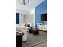 Stylish living room featuring a modern blue accent wall, comfortable seating, and contemporary decor at 6200 Sw 97Th St, Ocala, FL 34476