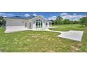 Lush backyard featuring a concrete patio perfect for outdoor entertaining and serene relaxation at 359 Terminal Ave, Polk City, FL 33868